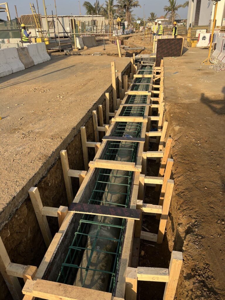 Timber formwork over a reinforced pipe encasement at first light