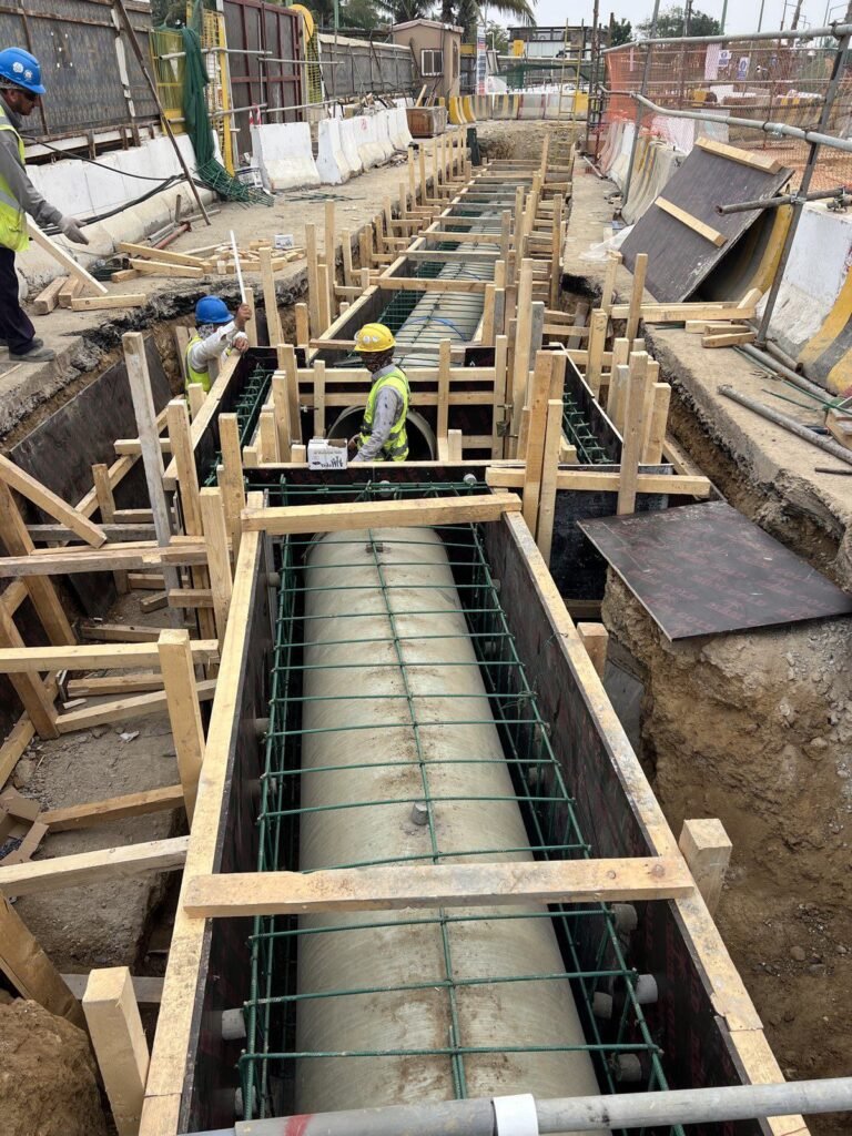 Large bore GRP pipe in a reinforcement cage inside a shored trench