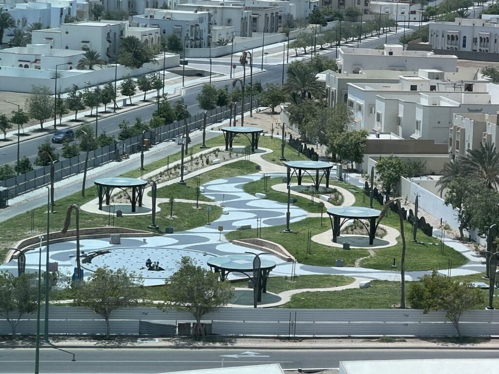 Aerial view of a finished park with circular shade gazebos